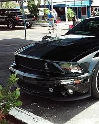 A black Shelby Mustang with racing stripes, hand washed down to the wheels and front splitter.