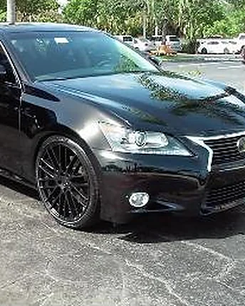 A black Lexus sedan on dark alloy wheels, hand washed and dried without a spot left behind.